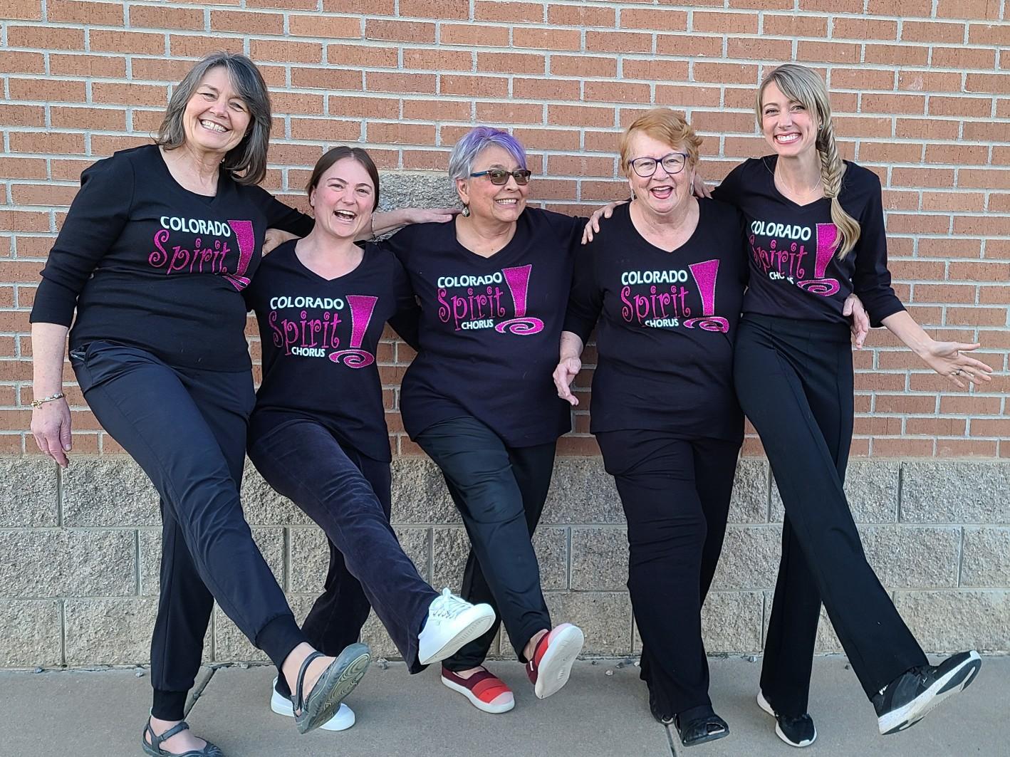 Five chorus members smiling